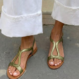 Golden flat sandals with back strap and cut-out pattern