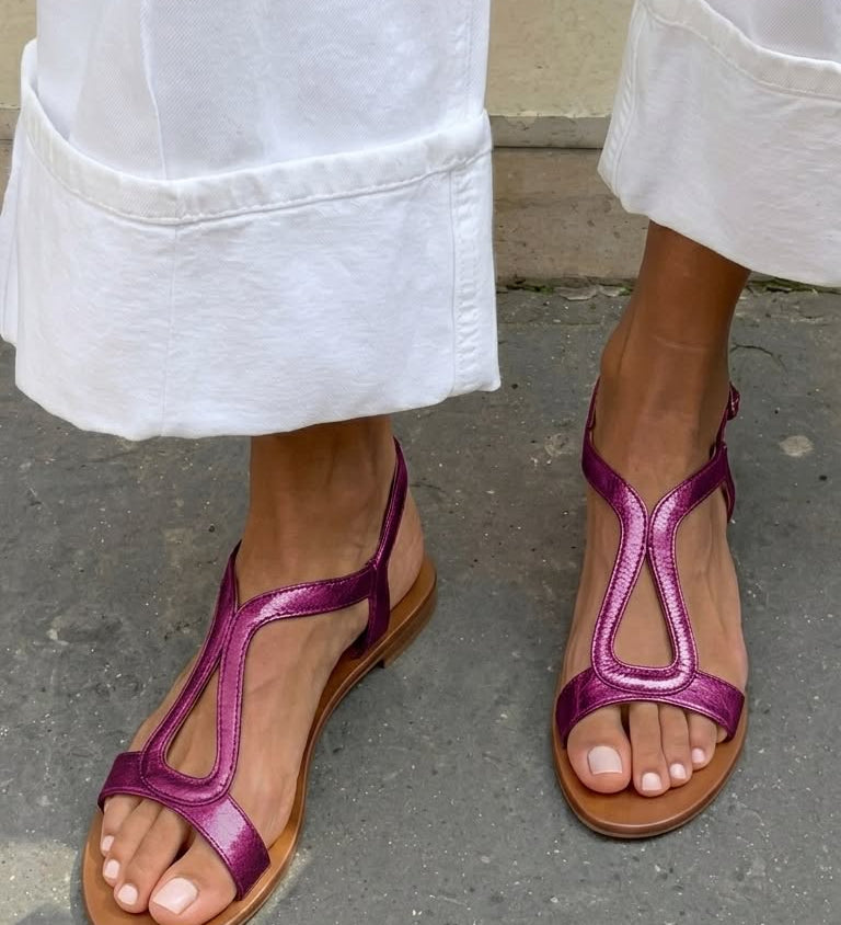 Golden flat sandals with back strap and cut-out pattern